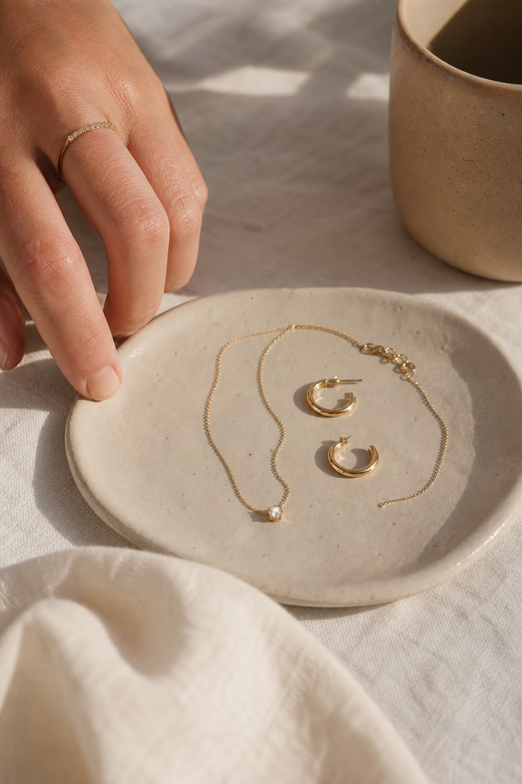 SEORA everyday gold jewelry on warm linen